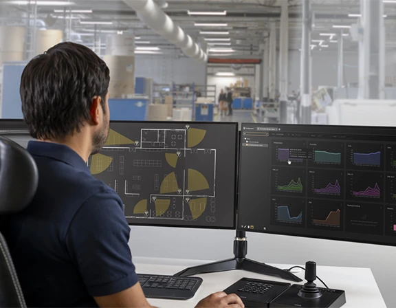 Man viewing security cameras controls