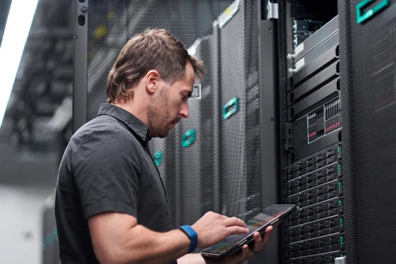 A data specialist reviewing server configurations on a tablet