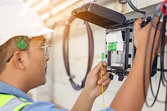 High Point Networks engineer running fiber optic network cabling